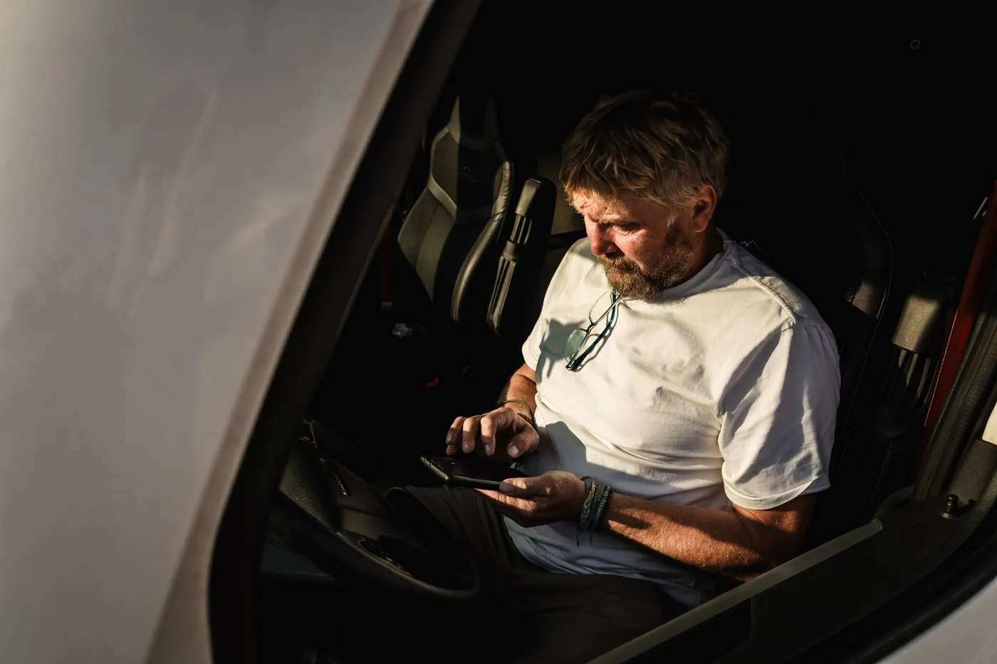 A driver resting comfortably in his sleeper at night, engine off