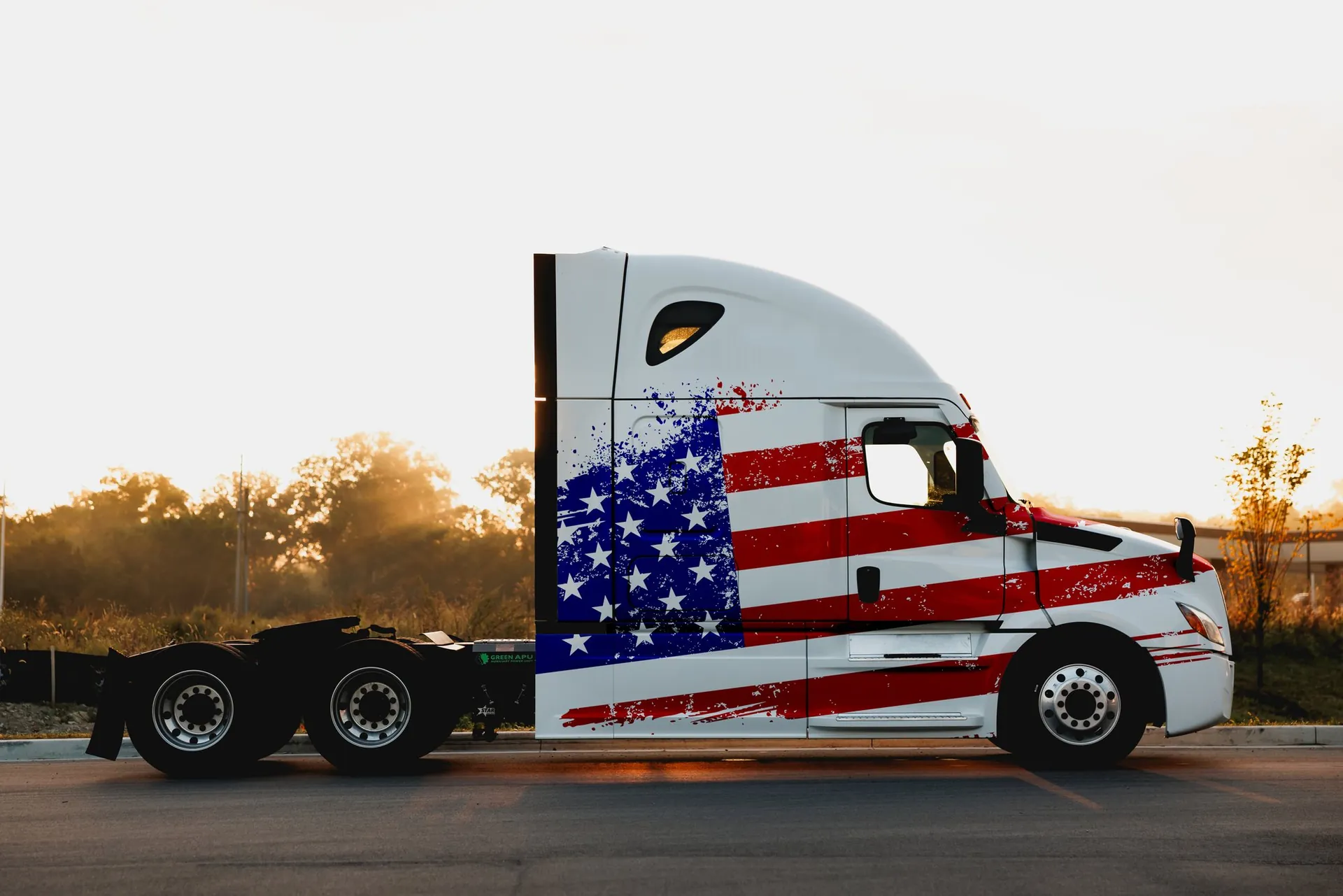 An American flag-wrapped semi-truck — Green APU racing heritage